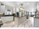 Spacious kitchen featuring white cabinetry, granite countertops, modern appliances, and adjoining dining area at 942 S County Road 129 Rd, Bennett, CO 80102