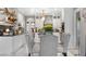 Stylish kitchen with white cabinets, black countertops, stainless steel appliances, and a glass dining table at 942 S County Road 129 Rd, Bennett, CO 80102