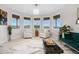 Bright living room with large windows, stylish seating, and elegant decor creates a cozy and inviting atmosphere at 942 S County Road 129 Rd, Bennett, CO 80102