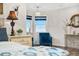 Bright main bedroom with a comfortable chair by the window and a decorative vanity at 942 S County Road 129 Rd, Bennett, CO 80102