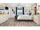 Comfortable main bedroom featuring wood floors, a decorative chandelier, and a cozy bed at 942 S County Road 129 Rd, Bennett, CO 80102