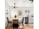 Cozy dining area features a wood table, black chairs, a modern light fixture, and hardwood floors at 133 S Xavier St, Denver, CO 80219