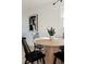 Dining area featuring a wooden table, surrounded by black chairs and accented by a decorative plant at 133 S Xavier St, Denver, CO 80219