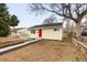 Well-kept single-story home with a bright red door, complemented by tidy landscaping and mature trees at 133 S Xavier St, Denver, CO 80219