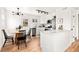 Modern kitchen with stainless steel appliances, white cabinets, and an eat-in dining area at 133 S Xavier St, Denver, CO 80219