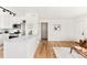 Bright and airy kitchen seamlessly flows into the adjacent living room at 133 S Xavier St, Denver, CO 80219