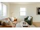 Bright living room features a soft rug, modern furniture, and natural light from windows at 133 S Xavier St, Denver, CO 80219