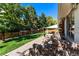 Landscaped backyard with patio and steps leading to the house at 3951 S Narcissus Way, Denver, CO 80237