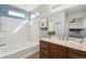Bathroom featuring a bathtub and shower combination with stylish vanity at 14881 E 117Th Ave, Commerce City, CO 80603