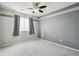 Neutral bedroom featuring grey paint, plush carpeting, and modern fan at 14881 E 117Th Ave, Commerce City, CO 80603