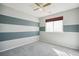 Stripped bedroom featuring blue and white paint and plush carpeting at 14881 E 117Th Ave, Commerce City, CO 80603