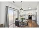 Bright dining area with sliding glass doors and wood-style flooring at 14881 E 117Th Ave, Commerce City, CO 80603