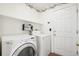 Functional laundry room with washer, dryer, and storage shelf at 14881 E 117Th Ave, Commerce City, CO 80603