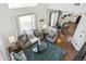 Open-concept living room and kitchen area with hardwood floors and ample natural light at 14881 E 117Th Ave, Commerce City, CO 80603