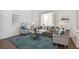 Cozy living room featuring a plush rug, comfortable seating, and hardwood floors at 14881 E 117Th Ave, Commerce City, CO 80603