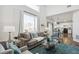 Bright living room featuring a large window and hardwood floors at 14881 E 117Th Ave, Commerce City, CO 80603
