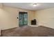 Finished basement features carpet, an efficient fireplace and a sliding glass door to the outside at 9209 William Cody Dr, Evergreen, CO 80439