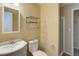 Cozy bathroom offering pedestal sink, framed mirror and a glassed in shower at 9209 William Cody Dr, Evergreen, CO 80439