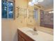 Bathroom with a single sink vanity and a large mirror, complemented by ample natural light at 9209 William Cody Dr, Evergreen, CO 80439