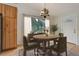 Bright dining room with a round table, wooden floors, and a view of the outside at 9209 William Cody Dr, Evergreen, CO 80439