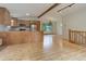 Open-concept kitchen with wood cabinets, stainless steel appliances, and light wood flooring at 9209 William Cody Dr, Evergreen, CO 80439