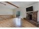 Bright living room with a stone fireplace and access to the deck at 9209 William Cody Dr, Evergreen, CO 80439