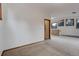 Cozy living room space with carpet floors, natural light, and an open layout at 9209 William Cody Dr, Evergreen, CO 80439