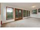Bright living room featuring large windows and a glass door with scenic wooded views at 9209 William Cody Dr, Evergreen, CO 80439