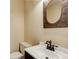 Powder room featuring modern fixtures, faucet, and mirror at 9209 William Cody Dr, Evergreen, CO 80439