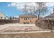 Backyard with rock garden, detached garage, and a wooden privacy fence at 1038 9Th Ave, Longmont, CO 80501