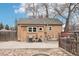 Backyard view with the house, wooden fence, detached garage, and grill at 1038 9Th Ave, Longmont, CO 80501