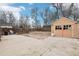 Fenced backyard with a concrete patio, detached garage, and a small rock garden at 1038 9Th Ave, Longmont, CO 80501