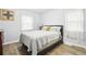 Cozy bedroom with wood floors, natural light, a comfortable bed, and neutral decor at 1038 9Th Ave, Longmont, CO 80501