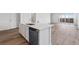Close-up of kitchen island with modern sink, dishwasher, and ample counter space at 19040 E 96Th Pl, Commerce City, CO 80022