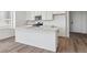 Well-lit kitchen with a large island featuring modern appliances and ample counter space at 19040 E 96Th Pl, Commerce City, CO 80022