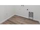 Practical laundry area featuring stylish wood flooring and essential utility connections at 19040 E 96Th Pl, Commerce City, CO 80022