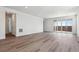 Open-concept living space with hardwood floors and sliding glass doors, creating a seamless indoor-outdoor flow at 19040 E 96Th Pl, Commerce City, CO 80022