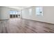Spacious living room featuring hardwood floors and sliding glass doors leading to outdoor views at 19040 E 96Th Pl, Commerce City, CO 80022