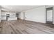 Bright, open floor plan with wood flooring connecting living, dining, and kitchen areas at 19040 E 96Th Pl, Commerce City, CO 80022