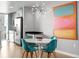 Modern dining area with a stylish light fixture and colorful artwork at 891 14Th St # 2505, Denver, CO 80202