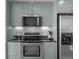 Close-up of the kitchen showcasing stainless steel appliances, including a stove, microwave, and refrigerator at 891 14Th St # 2505, Denver, CO 80202