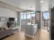 Bright living room with floor-to-ceiling windows offering city views at 891 14Th St # 2505, Denver, CO 80202