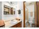 Well-lit bathroom with vanity, mirror, and tile flooring at 8025 W Eastman Pl # 2-102, Lakewood, CO 80227