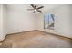 A bedroom is bright and spacious, with carpet, a ceiling fan, and a large window at 8025 W Eastman Pl # 2-102, Lakewood, CO 80227