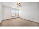 Bright bedroom with a ceiling fan, carpet, and a large window at 8025 W Eastman Pl # 2-102, Lakewood, CO 80227
