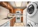 Efficient kitchen features white appliances, including a dishwasher, microwave, and stove oven at 8025 W Eastman Pl # 2-102, Lakewood, CO 80227