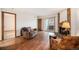 Cozy living room features a brick fireplace, wood floors, and sliding door to balcony at 8025 W Eastman Pl # 2-102, Lakewood, CO 80227