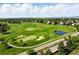 Breathtaking aerial view of a sprawling golf course featuring pristine fairways, sand traps, and scenic water features at 9556 Kemper Dr, Lone Tree, CO 80124