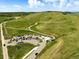 Aerial view displays a winding trail through a green hilly area, parking lot, and a green gazebo covered picnic area at 9556 Kemper Dr, Lone Tree, CO 80124