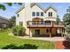 Backyard view of a home featuring a spacious deck, well-maintained lawn, and mature trees at 9556 Kemper Dr, Lone Tree, CO 80124